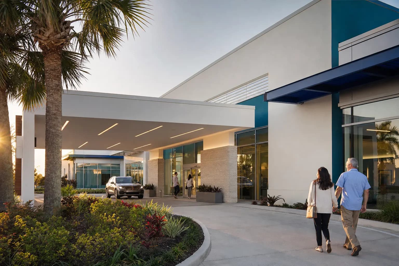 Exterior of a modern outpatient surgery center with palm trees at sunset